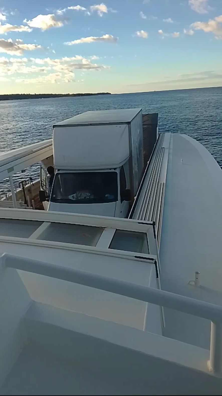 Camion à bord d’un bateau, avec la mer en arrière-plan